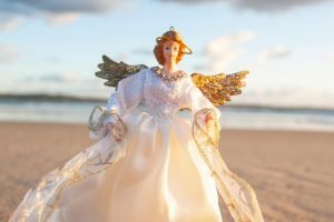 photo by Photo by Karen Laårk Boshoff: https://www.pexels.com/photo/a-white-and-gold-angel-doll-with-halo-9523752/